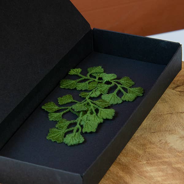 Open black gift box containing the Botanopia Maidenhair fern embroidery brooch.