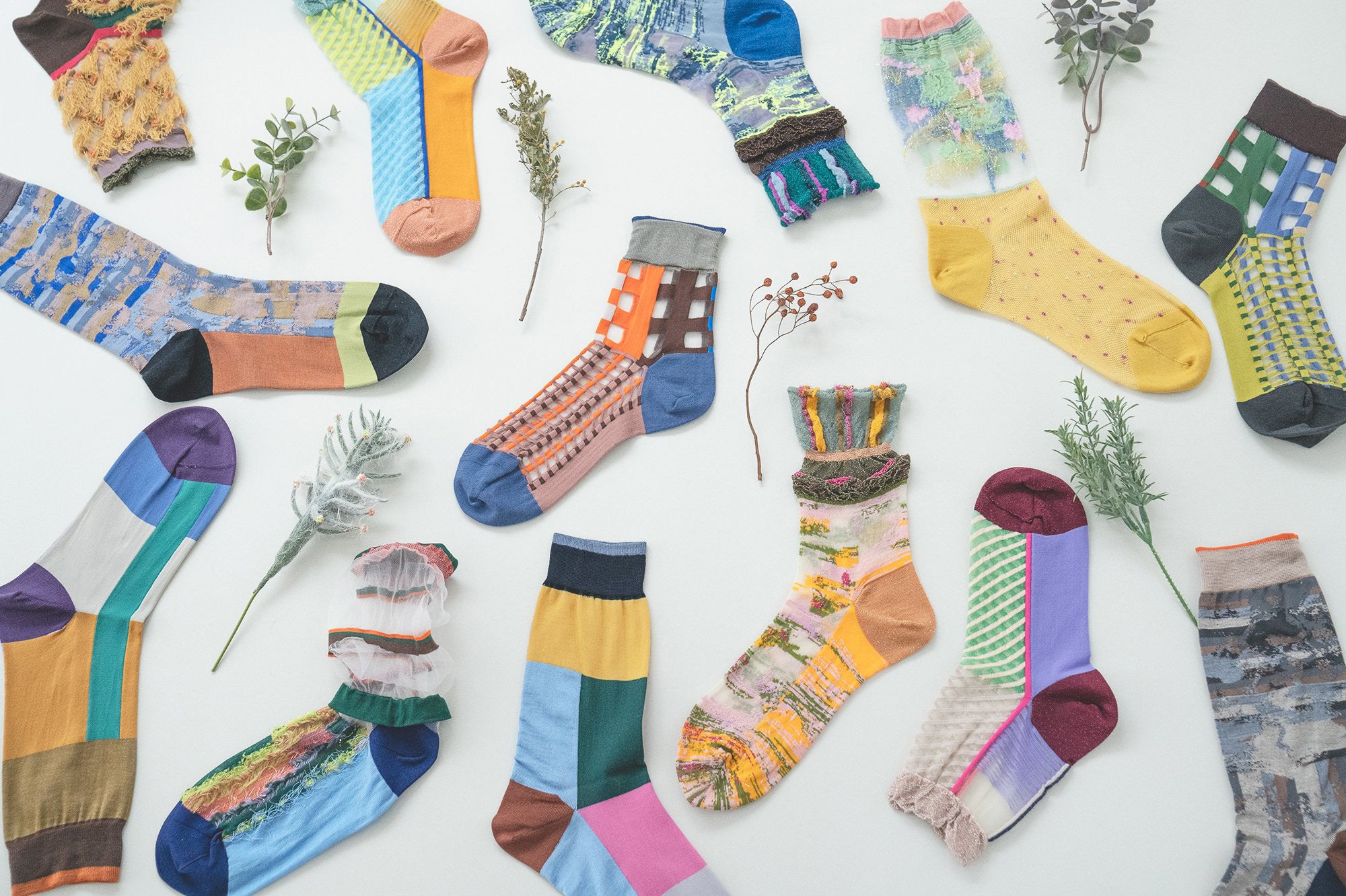 Photo featuring a collection of COQ Sunlight Block Socks in various colors, including black, blue, yellow, and others, each showcasing different styles, patterns, and textures.