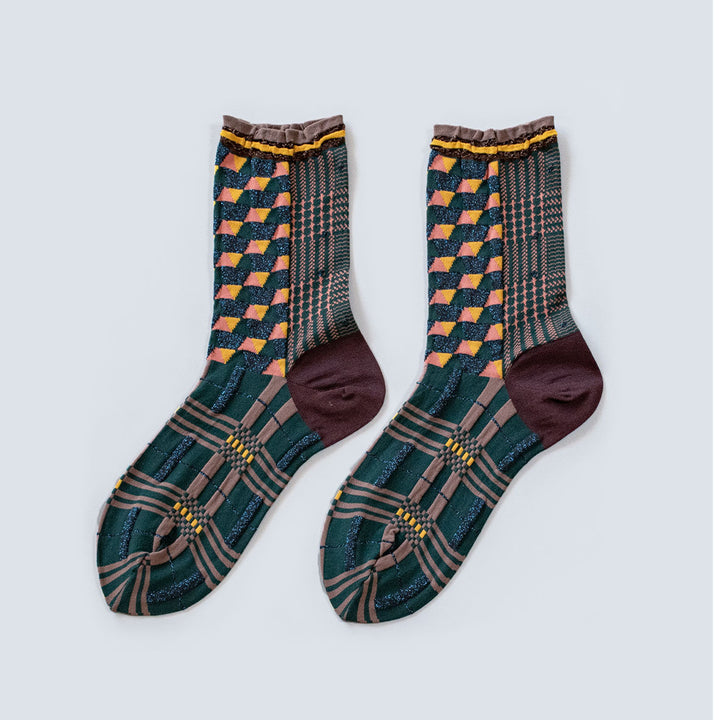 Image of the Antique Patch Dark Green socks, featuring various geometric patterns in shades of dark green, brown, and yellow.