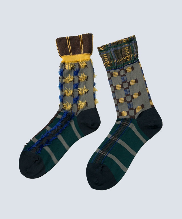 Image of the Atelier Textiles Charcoal Grey socks, showcasing multiple geometric patterns and styles, highlighting their versatility and craftsmanship, made in Japan.