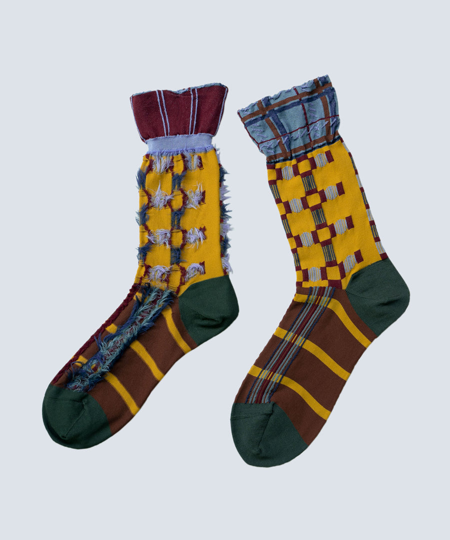 Image of the Atelier Textiles Yellow socks, showcasing multiple geometric patterns and styles, highlighting their versatility and craftsmanship, made in Japan.