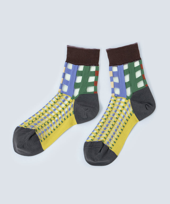 Close-up image of COQ Picnic Window Socks in green, made in Japan, showcasing the checked pattern and translucent design details.