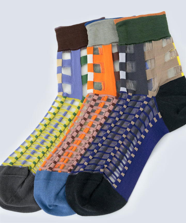 Image showcasing COQ Picnic Window Socks in three colours: orange, navy, and green, made in Japan, highlighting their checked pattern and translucent design.