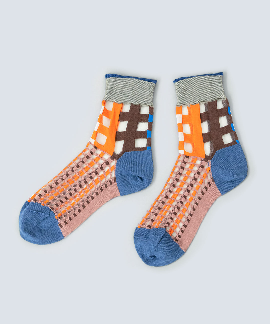 Close-up image of COQ Picnic Window Socks in orange, made in Japan, showcasing the checked pattern and translucent design details.