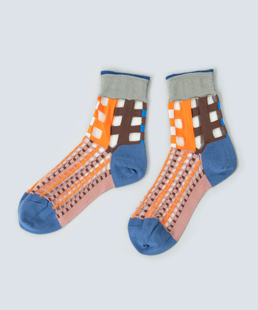 Close-up image of COQ Picnic Window Socks in orange, made in Japan, showcasing the checked pattern and translucent design details.