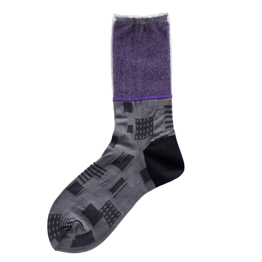 Image of a single COQ Sunlight Block Sock in black and purple, showcasing its geometric patterns and varying textures and fabrics.