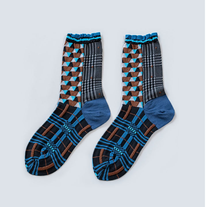 Image of the Antique Patch Blue socks, featuring various geometric patterns in shades of blue, brown, and black.