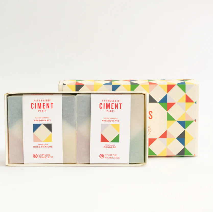 Opened organic Ciment Arlequin soap gift box displaying two colorful soaps inside with vibrant geometric patterns.