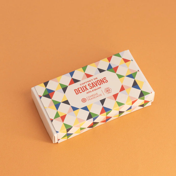 Organic Ciment Arlequin soap gift box set with vibrant geometric patterns in bright colors, placed on an orange backdrop.