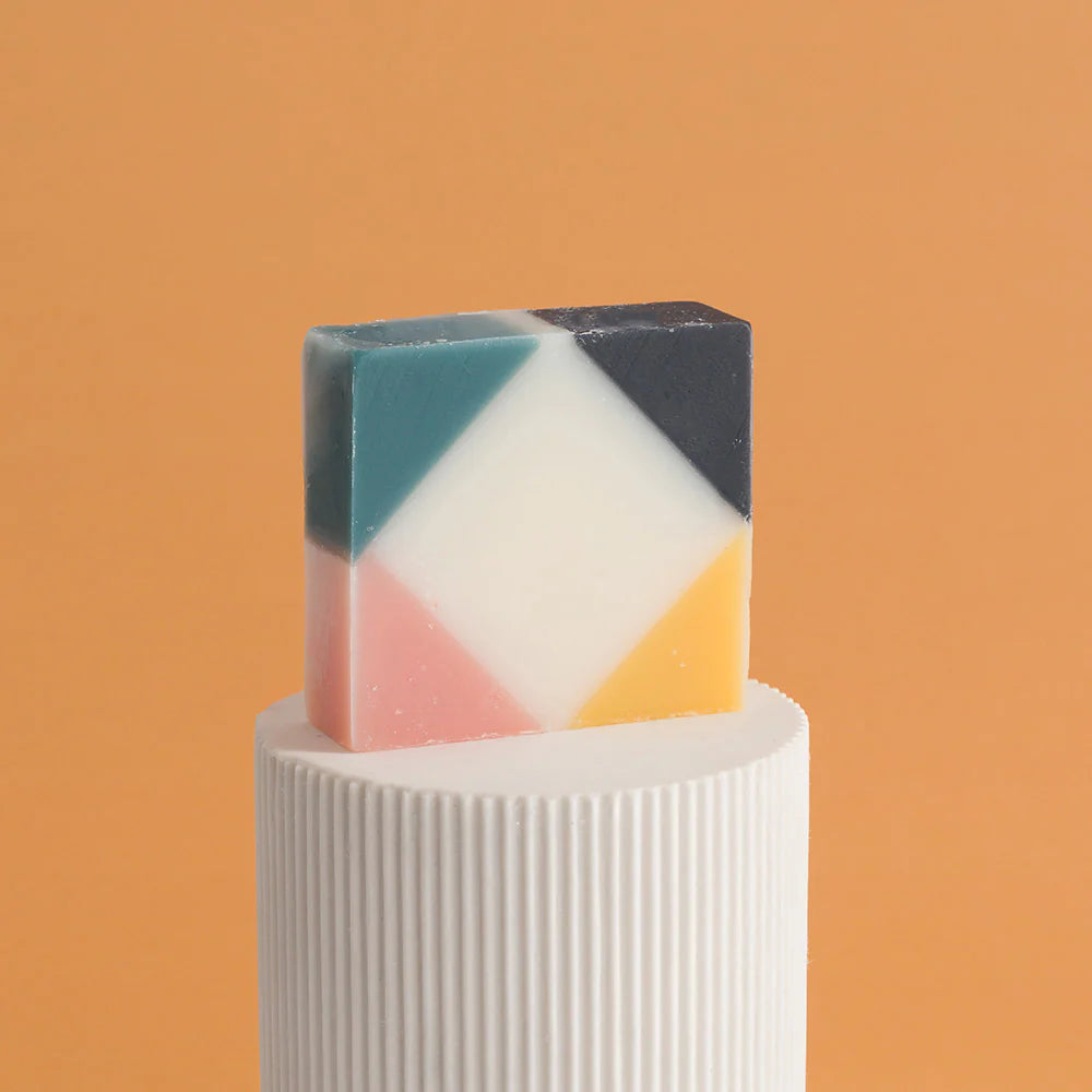 Colourful organic Ciment Arlequin soap  unwrapped, with a rose scent.