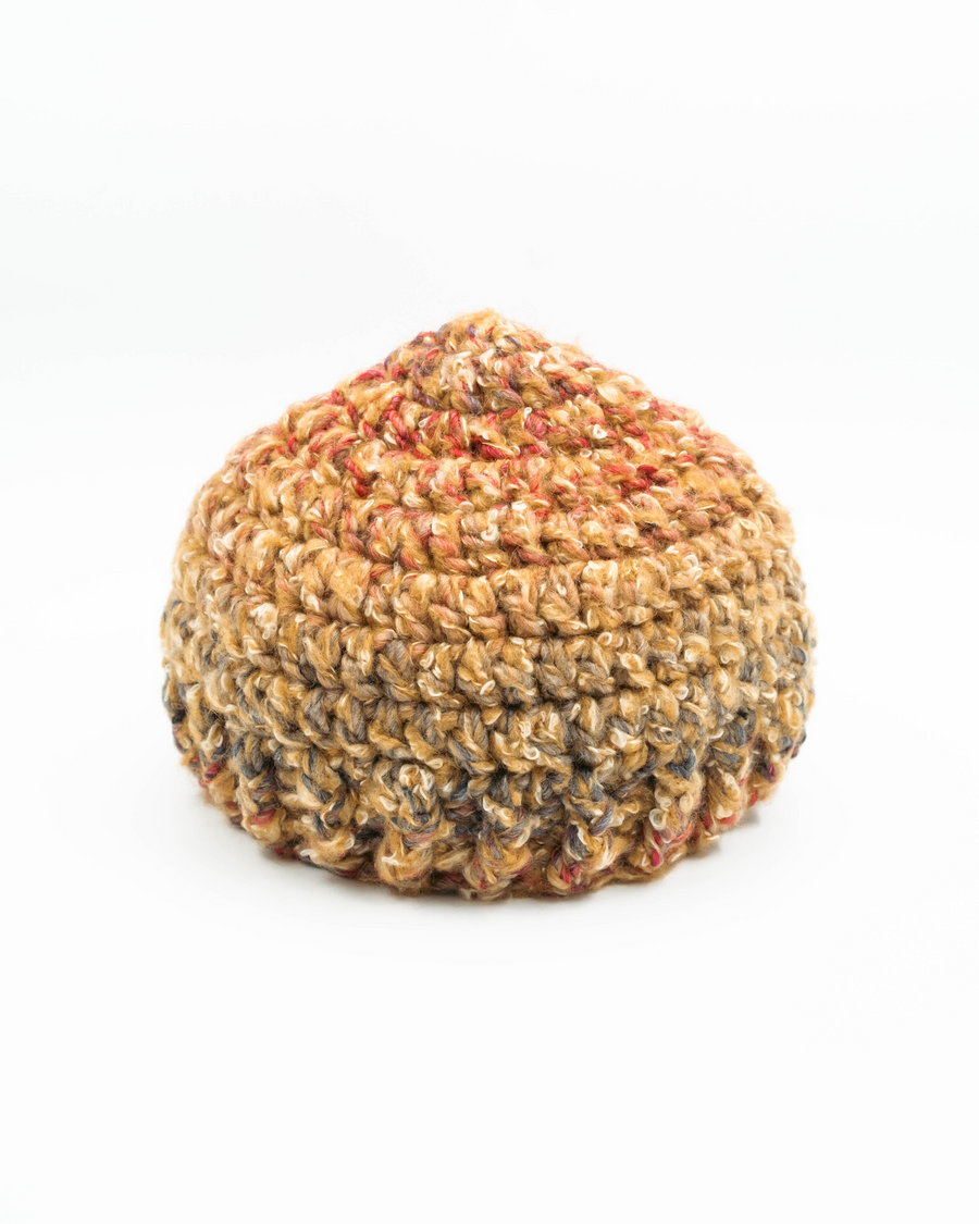 Round, textured crochet beanie on a white background