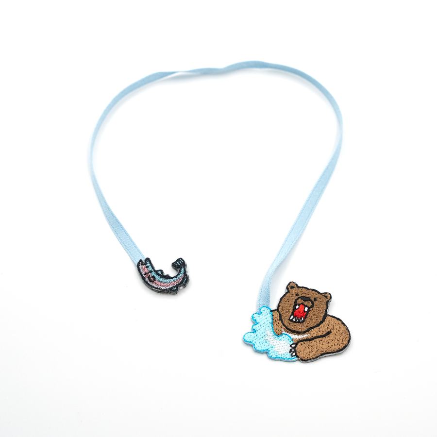 Bookmark with a bear and a fish on a white background