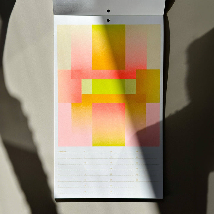 Risogrpah birthday calendar with colorful geometric design on a plain background