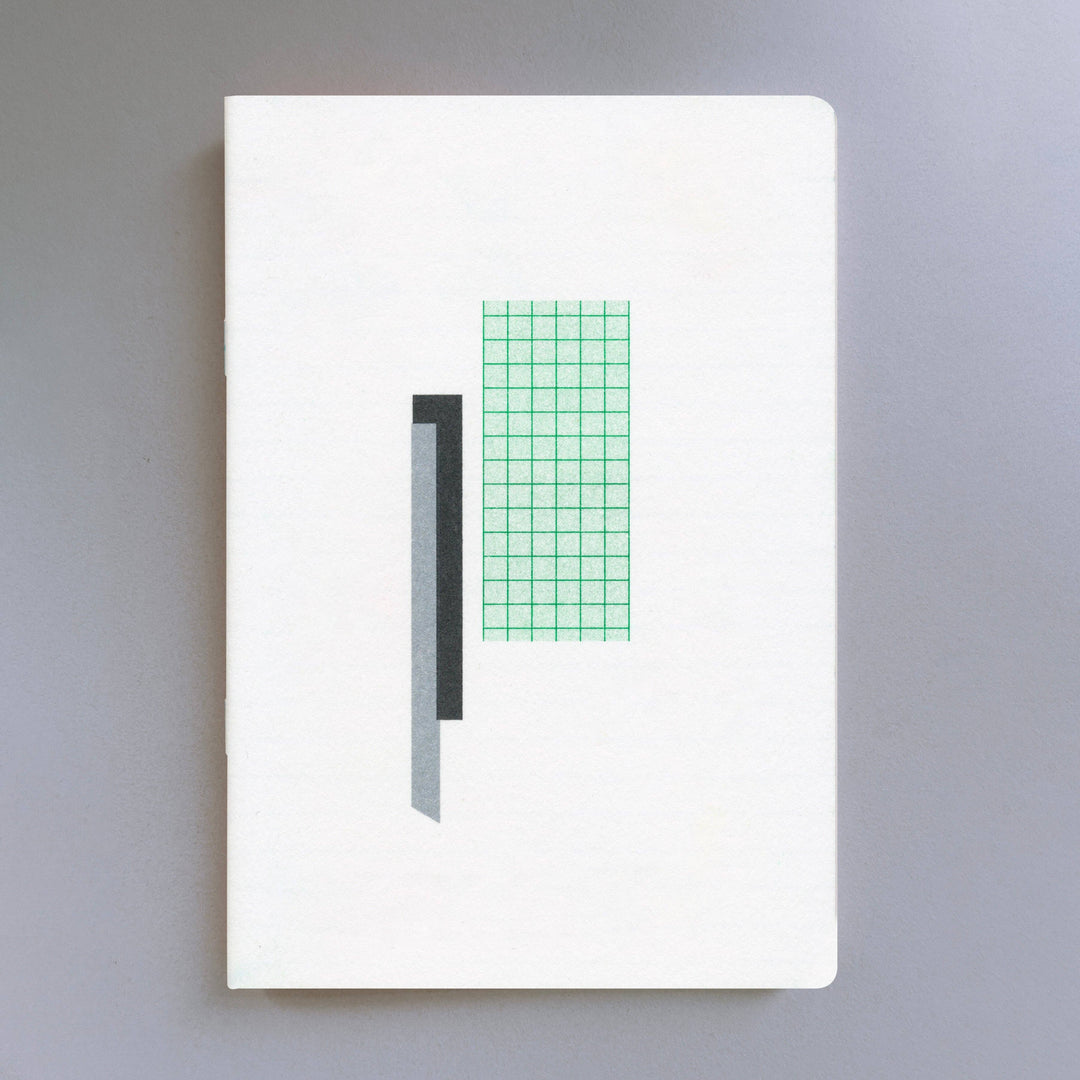 Risograph white notebook with green grid pattern on a gray background