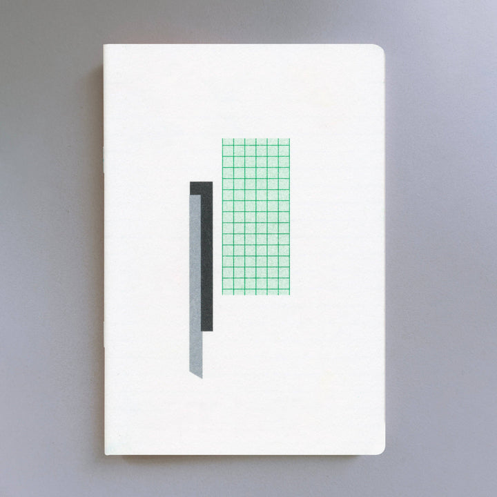 Risograph white notebook with green grid pattern on a gray background