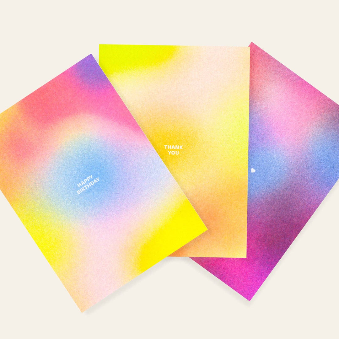 Three colorful risograph greeting cards with gradient designs on a white background