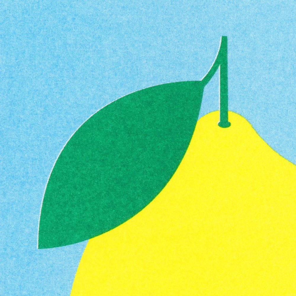 Yellow pear with a green leaf on a blue background