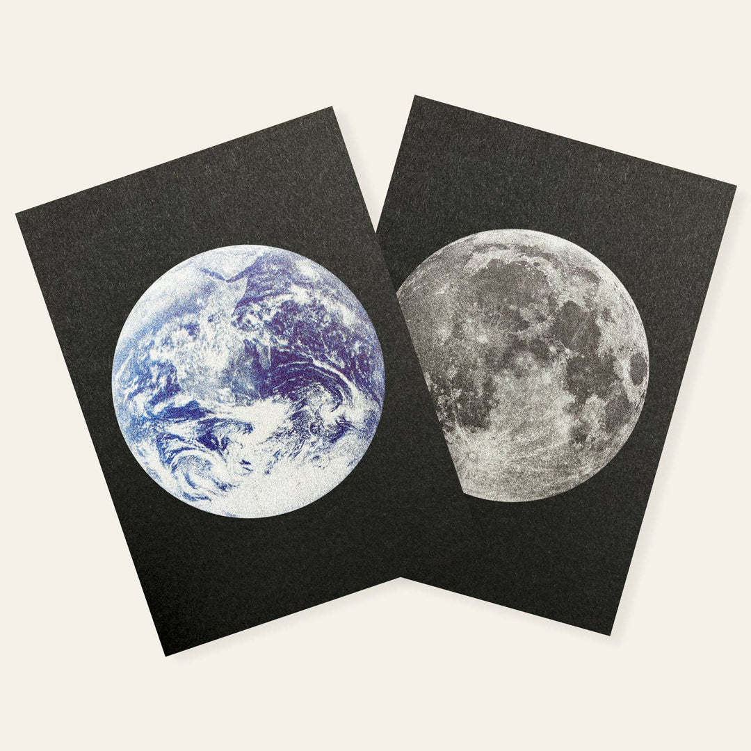 Two black postcards with images of Earth and the moon
