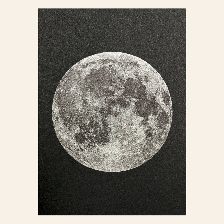 Detailed image of the moon on a textured black risograph postcard