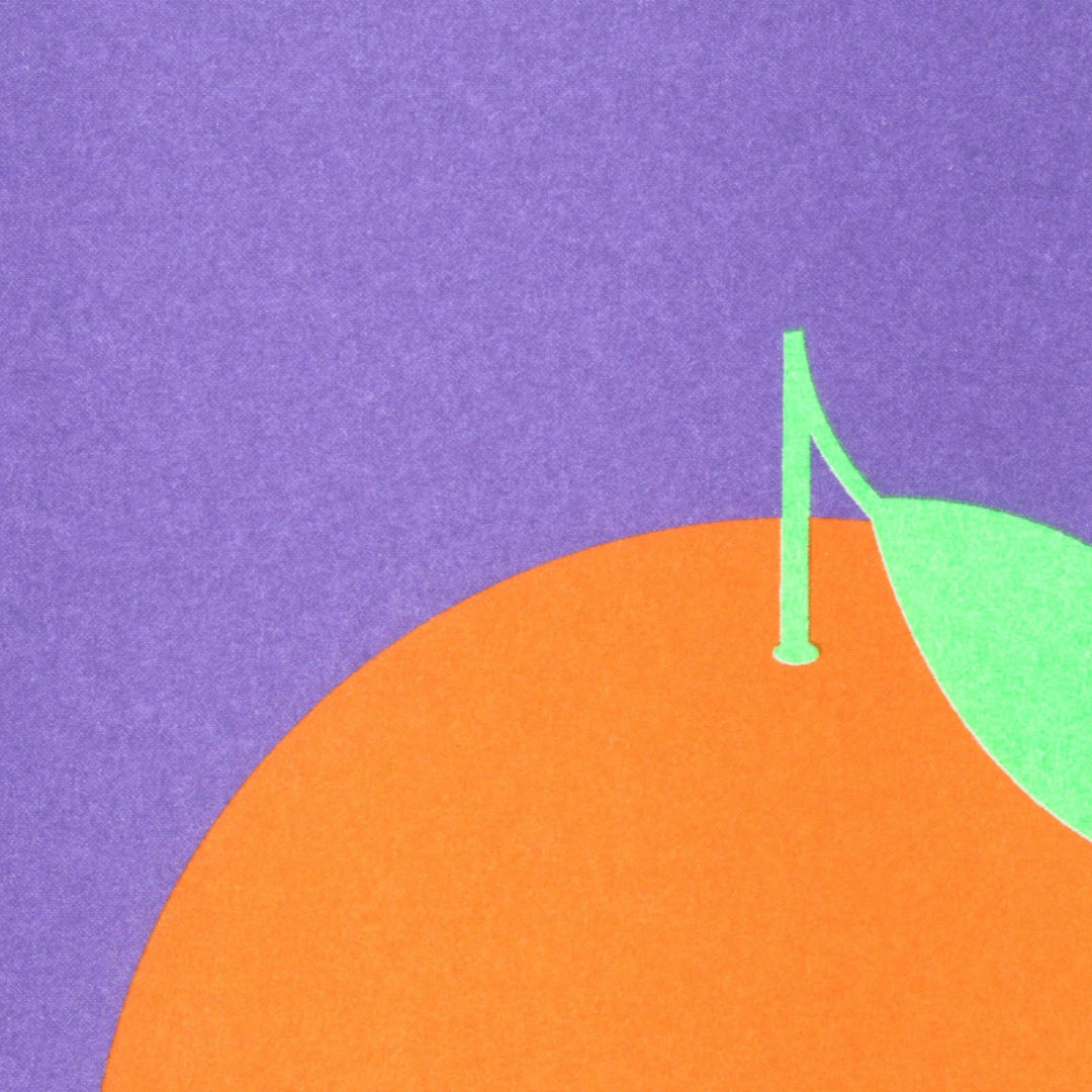 Orange fruit with a green leaf on a purple background