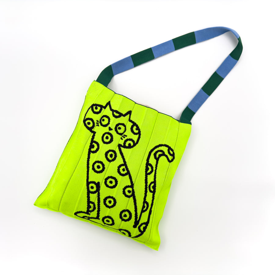 Image of the KNT 365 Knitty Tote Bag in neon yellow, featuring a bold leopard or cat illustration and striped straps, highlighting its vibrant colour and unique design.