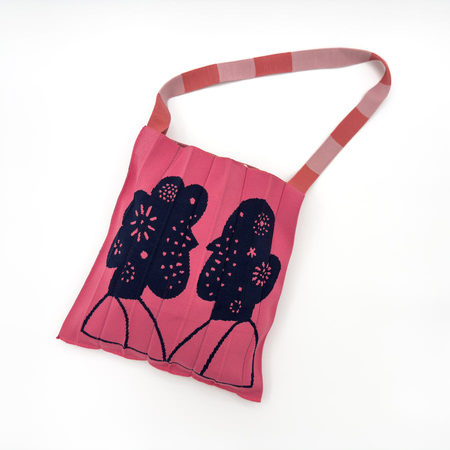 Image of the KNT 365 Knitty Tote Bag, handmade in Japan, featuring two illustrations of a human with flowers, and designed with stylish striped straps, highlighting its unique design and craftsmanship.