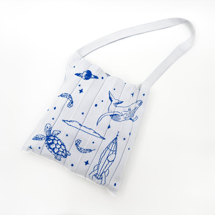 Image of the KNT 365 Knitty Tote Bag in white, featuring illustrations of space, planets, and animals, handmade in Japan, showcasing its unique and artistic design.