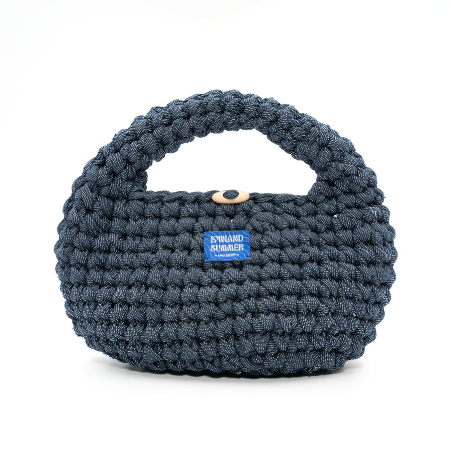 Blue woven handbag with a visible brand label on a white background