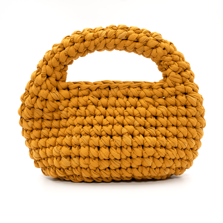Yellow woven handbag on a white background