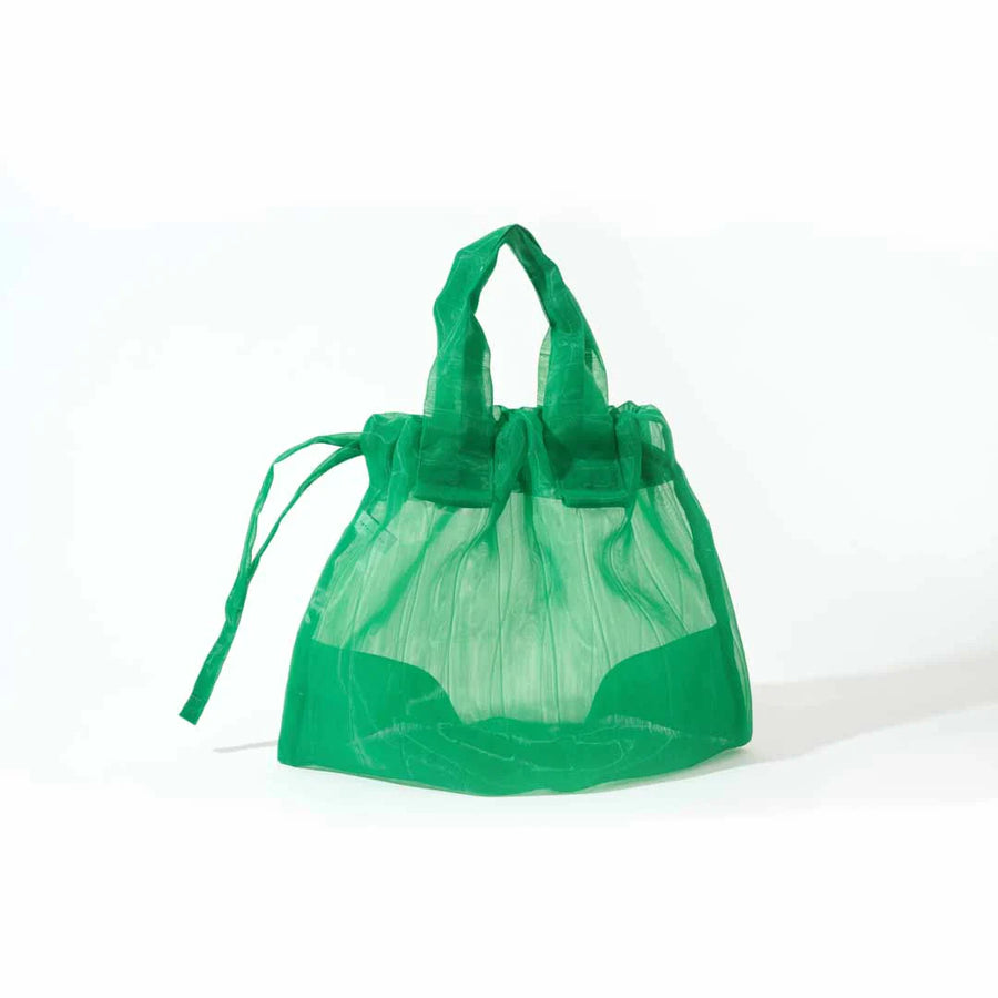 Image showcasing a Japan Mate Mono see-through bag in green, stylishly displayed against a clean white background.