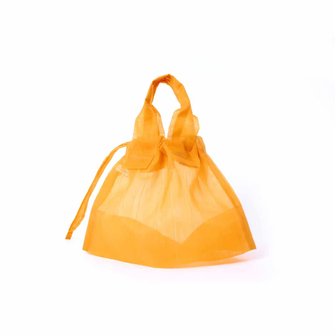 Image showcasing a Japan Mate Mono see-through bag in orange, stylishly displayed against a clean white background.