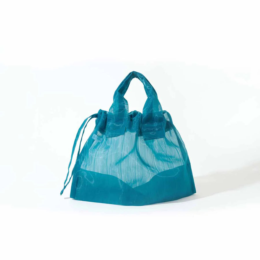 Image showcasing a Japan Mate Mono see-through bag in teal, stylishly displayed against a clean white background.