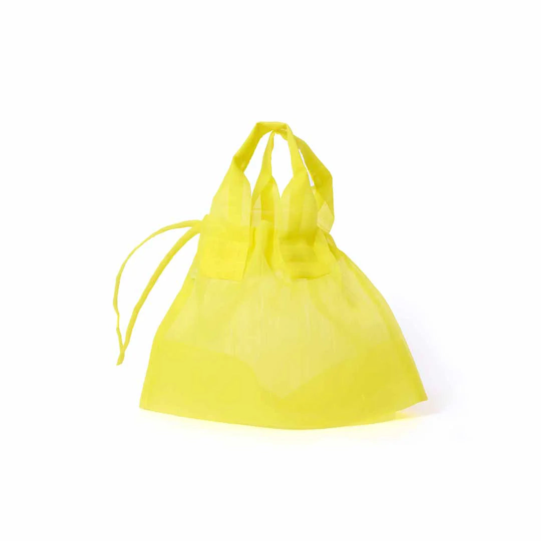 Image showcasing a Japan Mate Mono see-through bag in yellow, stylishly displayed against a clean white background.