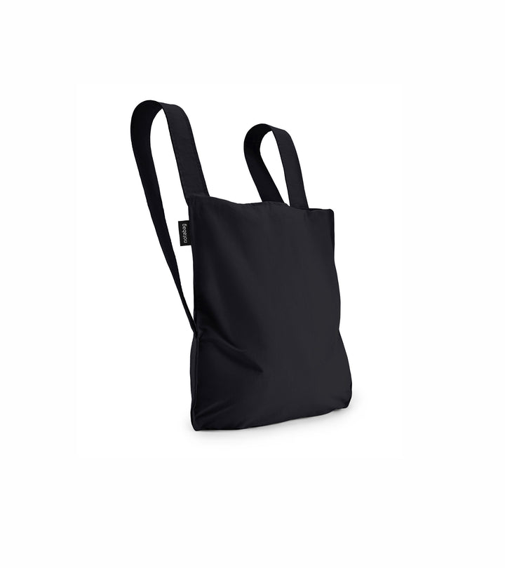 Product shot of the black original Notabag displayed in its backpack style, showcasing its sleek design and adjustable straps.