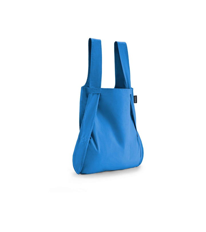 Image of a blue Notabag displayed in its backpack shape, showcasing its versatility and design.