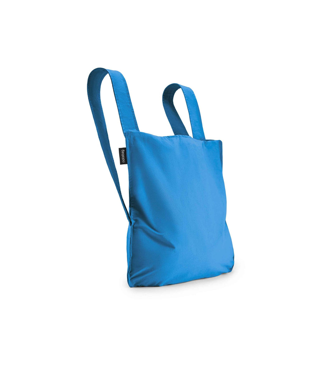 Image of a blue Notabag displayed in its backpack shape, showcasing its versatility and design.