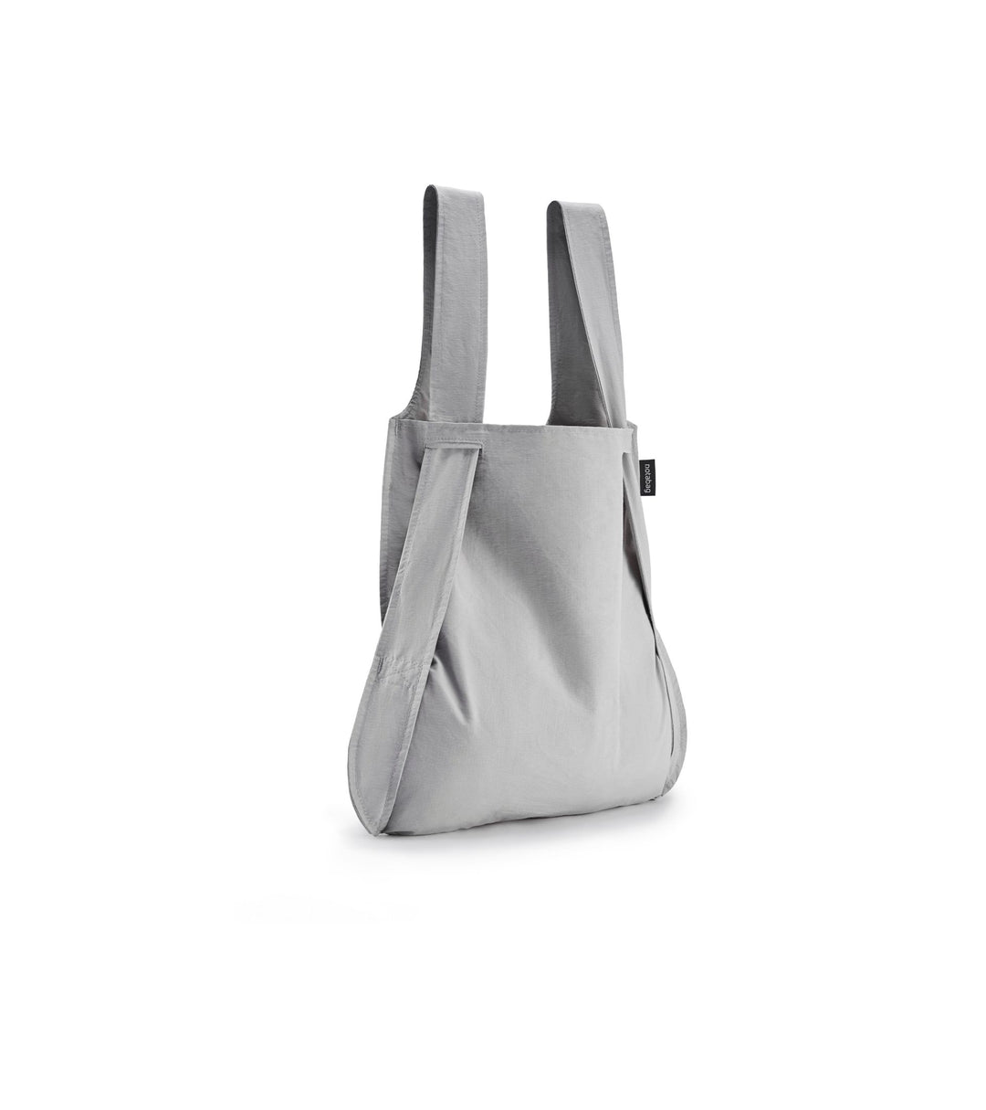 Image of a grey Notabag displayed in its backpack shape, showcasing its versatility and design.