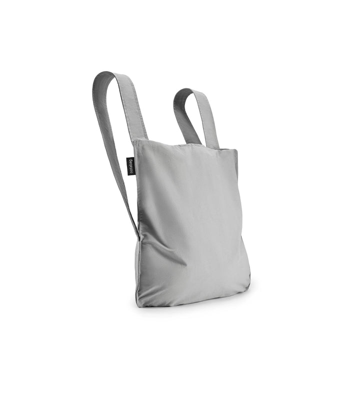 Image of a grey Notabag displayed in its backpack shape, showcasing its versatility and design.