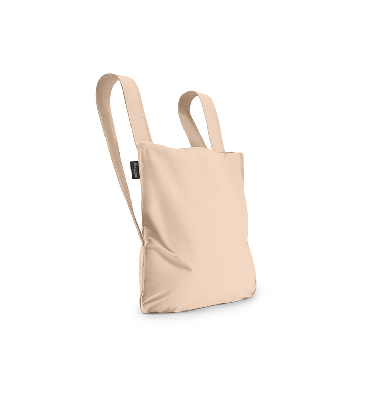 Image of a sand beige Notabag displayed in its backpack shape, showcasing its versatility and design.