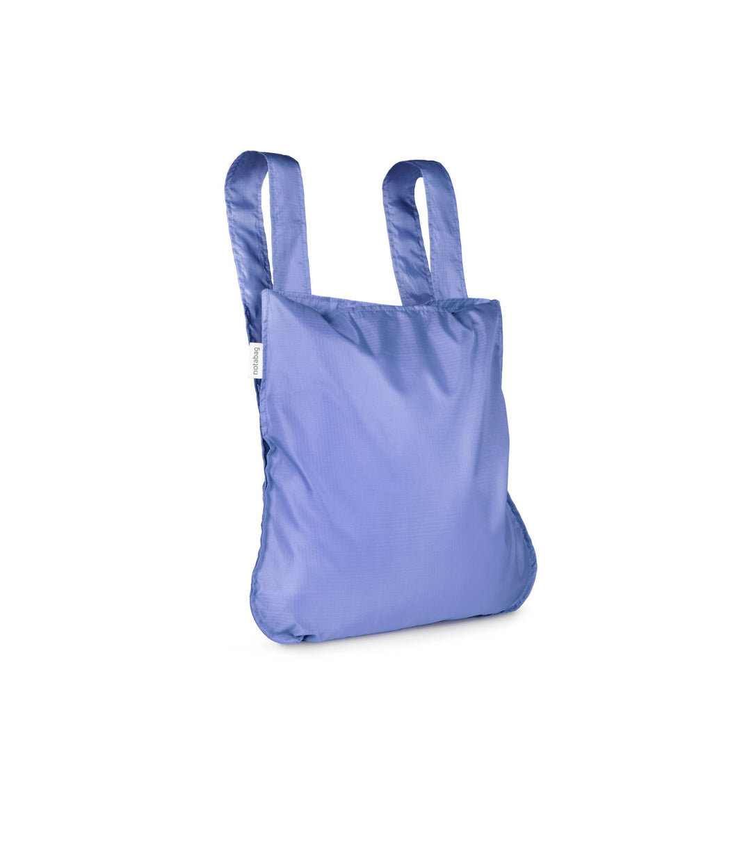 Image of a cornflower purple Notabag displayed in its backpack shape, showcasing its versatility and design.