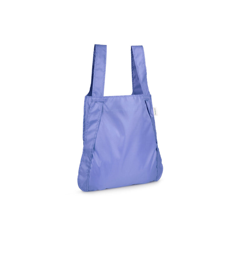 Image of a mustard cornflower purple Notabag displayed in its backpack shape, showcasing its versatility and design.