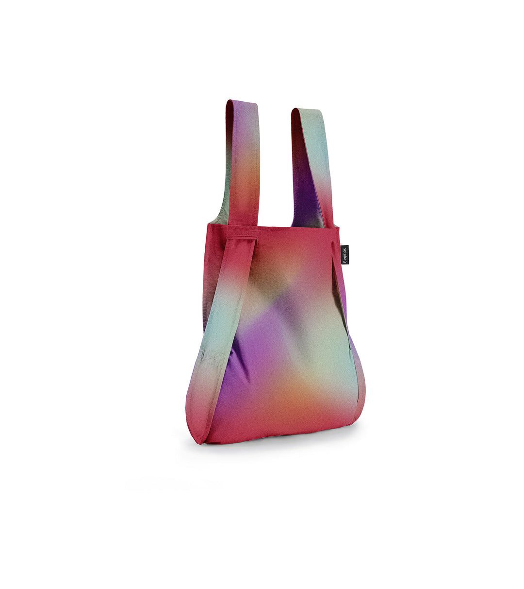 Image of a Notabag displayed in its backpack shape, designed to resemble a sunbeam with vibrant colours of red, purple, orange, and green, showcasing its versatility and unique design.