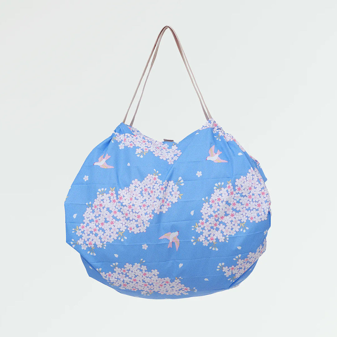 Blue bag with floral pattern on a light gray background