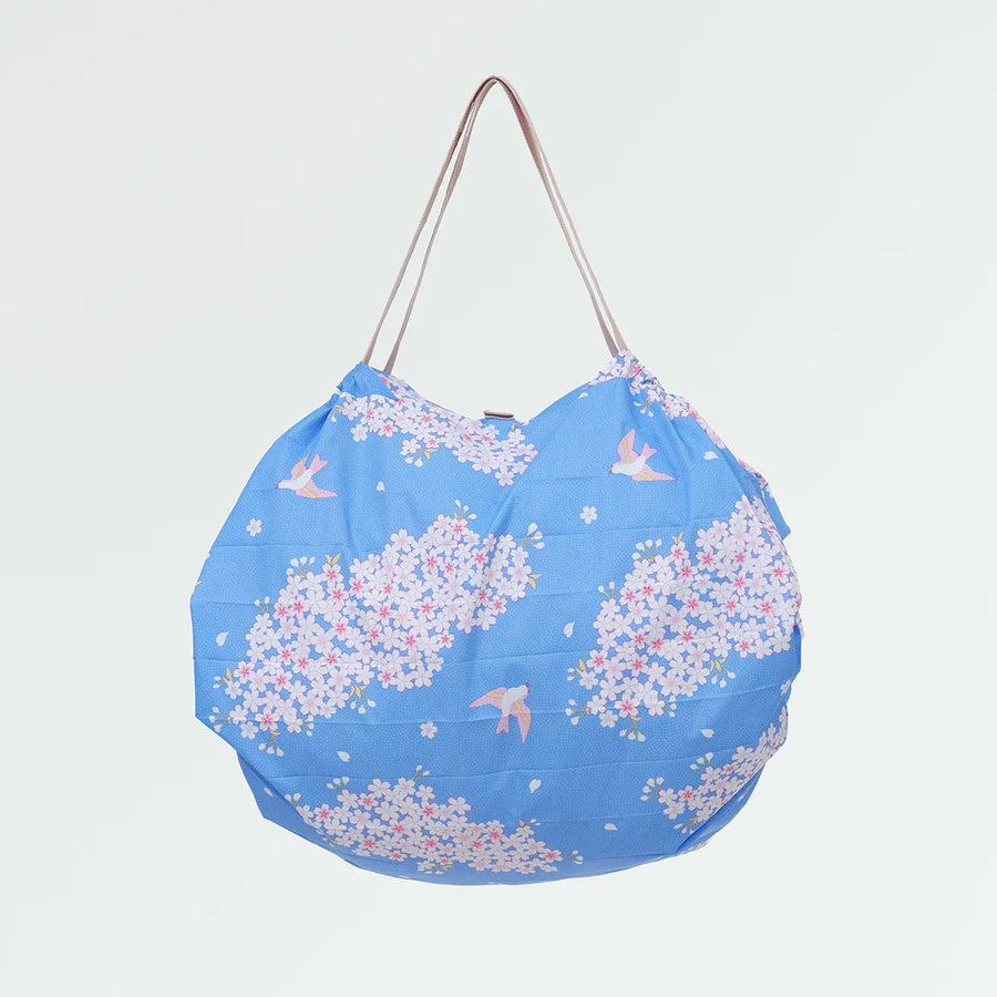 Blue bag with floral pattern on a light gray background