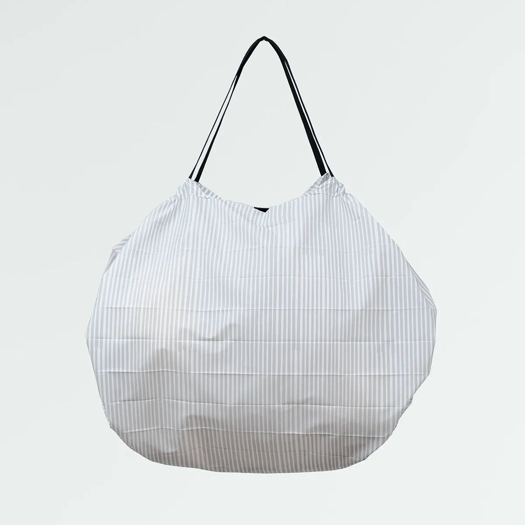 White mesh shopping bag with black handle on a light gray background