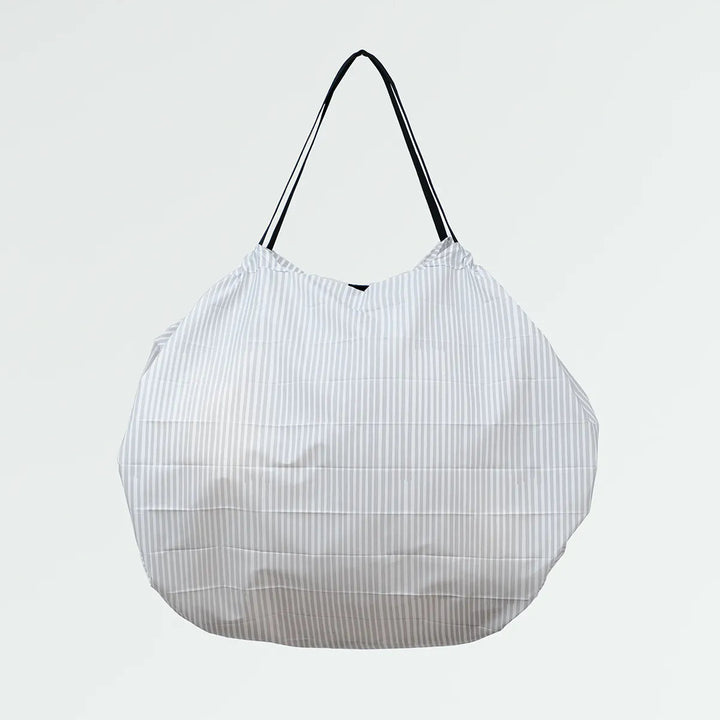 White mesh shopping bag with black handle on a light gray background