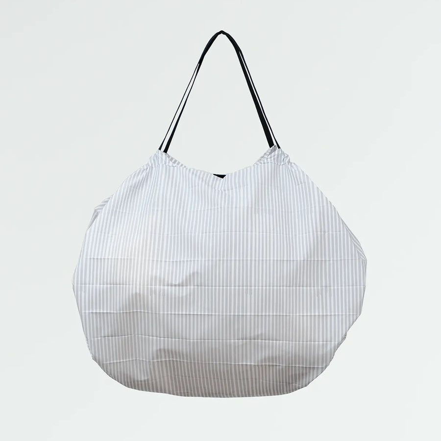White mesh shopping bag with black handle on a light gray background