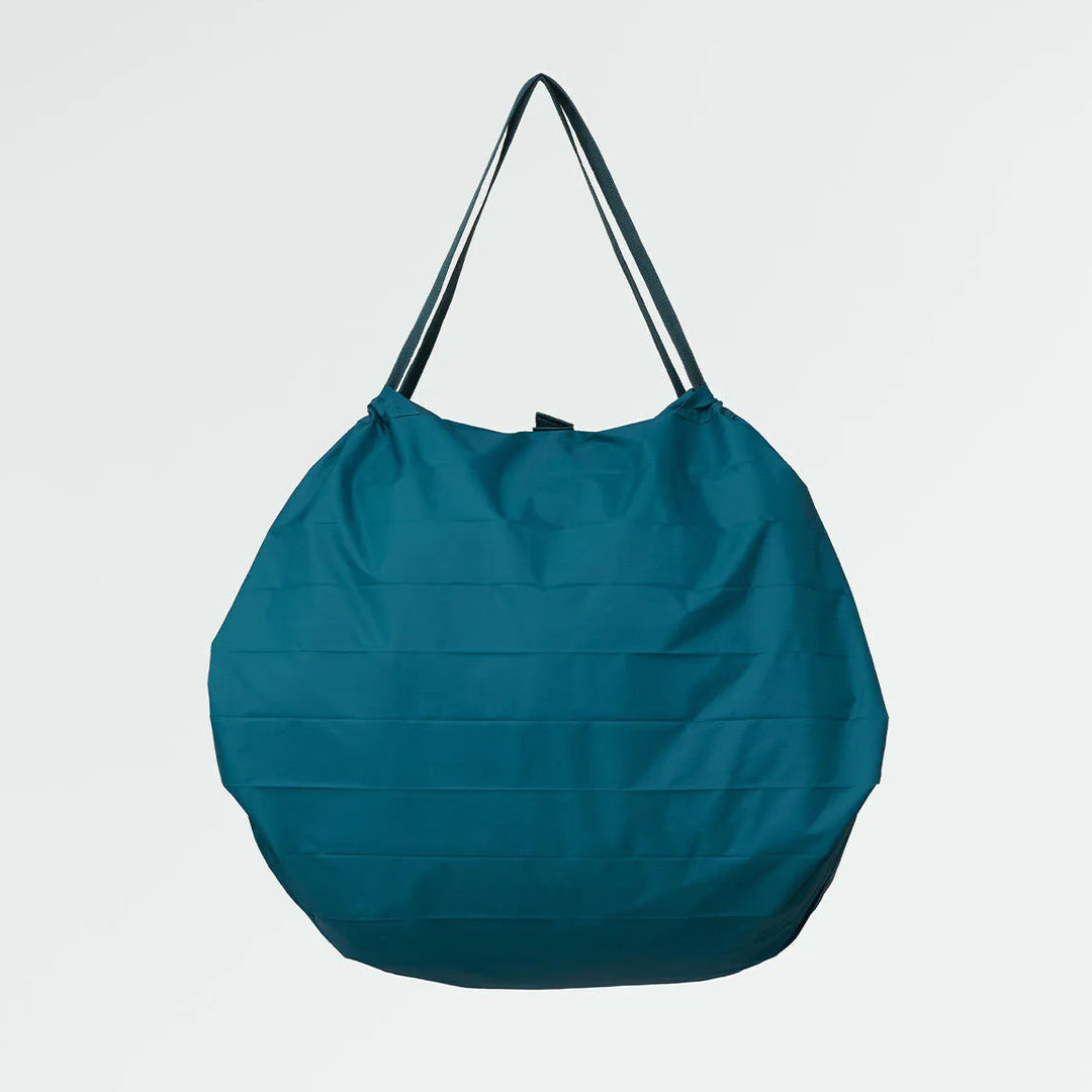 Teal bag with black straps on a light gray background