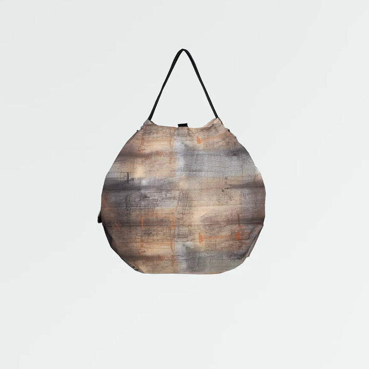 Patterned Shupatto bag on a light gray background