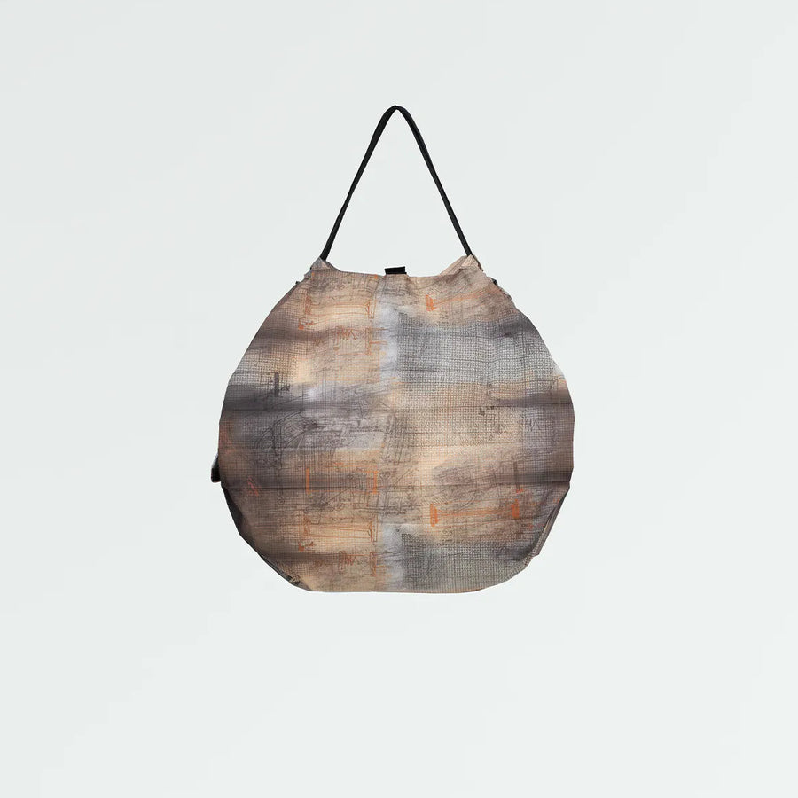 Patterned Shupatto bag on a light gray background